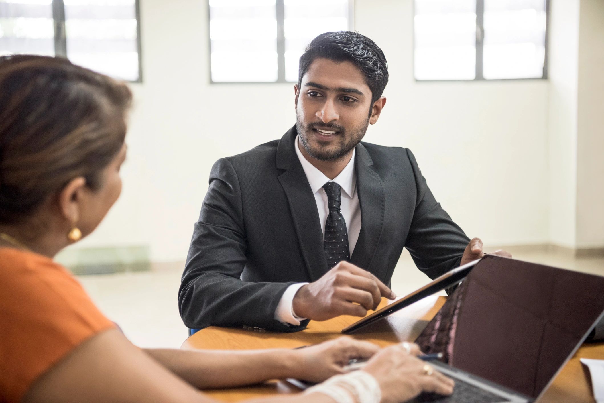 Executive coaching conversation in a modern office